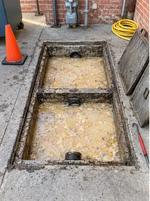 Full restaurant grease interceptor before cleaning in Waxahachie